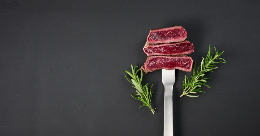 a blue steak sliced on a fork